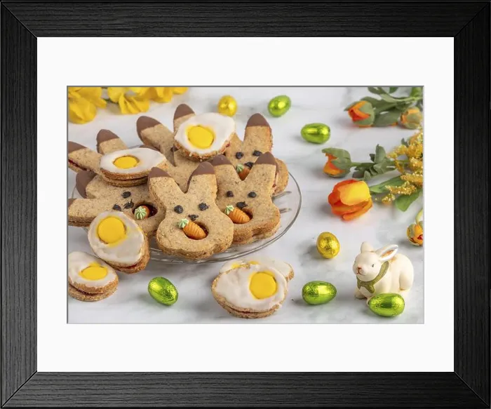 Framed Print : Bunny biscuits and egg biscuits decorated with icing next to Easter eggs and spring flowers Framed Print : Bunny biscuits and egg biscuits decorated with icing next to Easter eggs and spring flowers