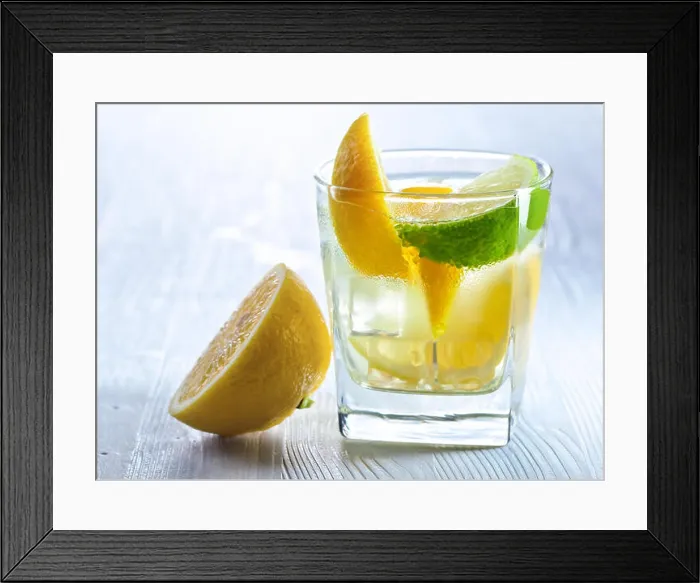 Framed Print : gin and tonic with lemon and ice on wooden table Framed Print : gin and tonic with lemon and ice on wooden table