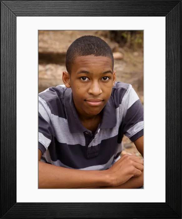 Framed Print : Handsome African-American Male sitting in outdoor setting Framed Print : Handsome African-American Male sitting in outdoor setting