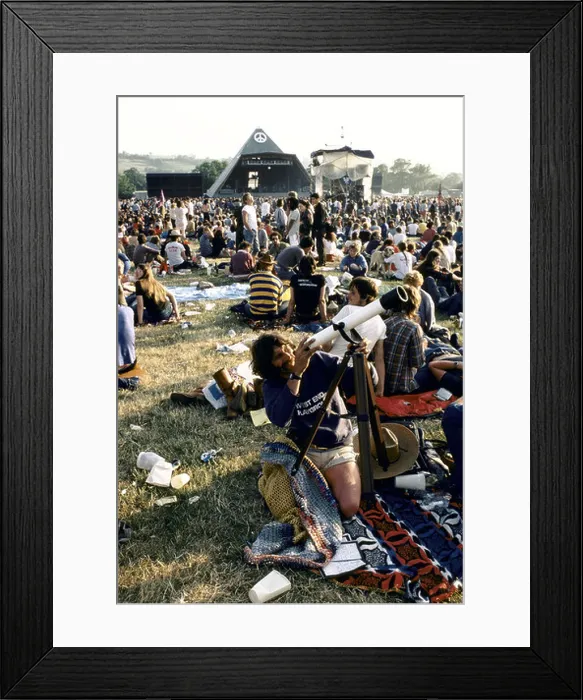 Framed Print : Looking through a telescope at the Glastonbury festival somerset 1983 Framed Print : Looking through a telescope at the Glastonbury festival somerset 1983
