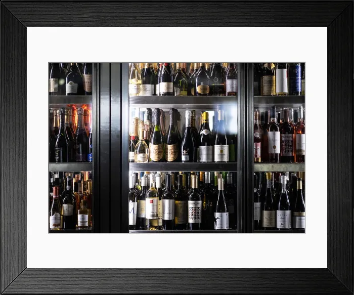 Framed Print : Wine bottles in large cooler fridge at a restaurant Framed Print : Wine bottles in large cooler fridge at a restaurant