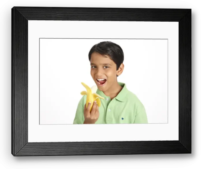 Framed Print : Ten year old boy showing half peeled yellow banana holding in hand MR#703V Framed Print : Ten year old boy showing half peeled yellow banana holding in hand MR#703V