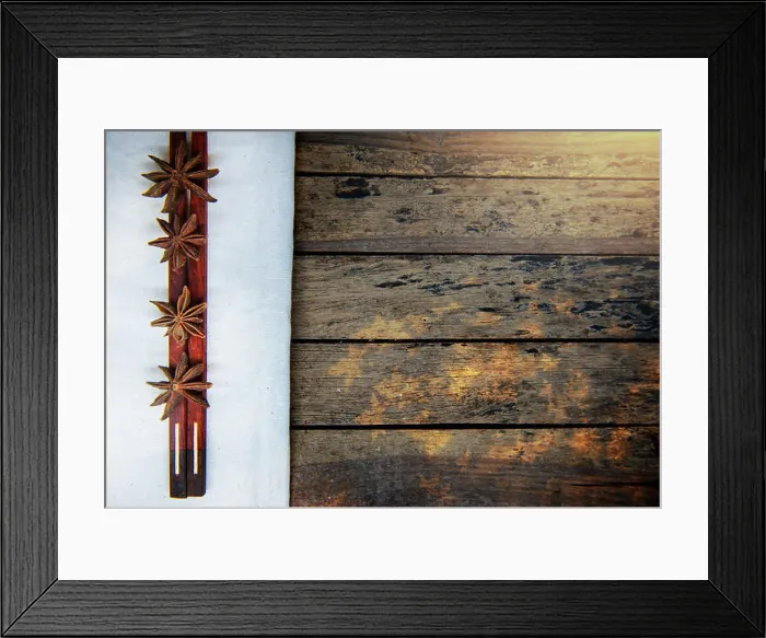 Framed Print : Warming spices - Star anise with wooden chopsticks on vintage wood table Framed Print : Warming spices - Star anise with wooden chopsticks on vintage wood table