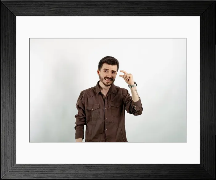 Framed Print : Young man smiling confident wearing casual clothes posing isolated over white background looking at camera showing