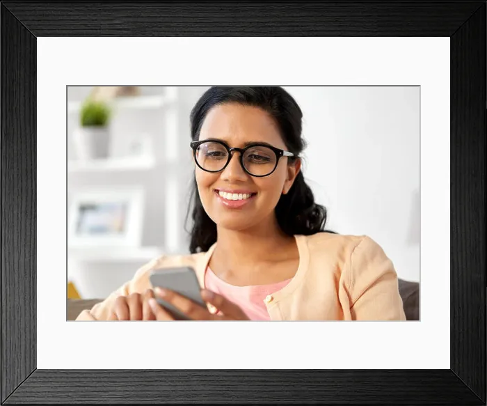 Framed Print : happy indian woman using smartphone at home Framed Print : happy indian woman using smartphone at home