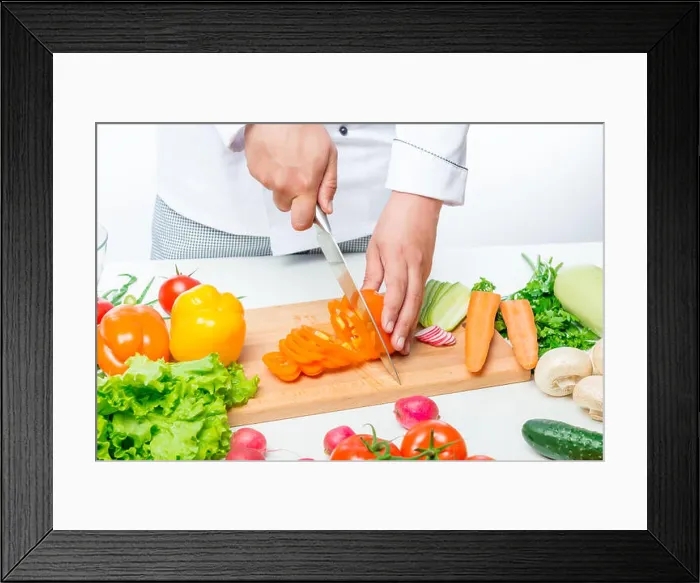 Framed Print : Chef cuts carefully sweet orange peppers for a vegetable salad Framed Print : Chef cuts carefully sweet orange peppers for a vegetable salad