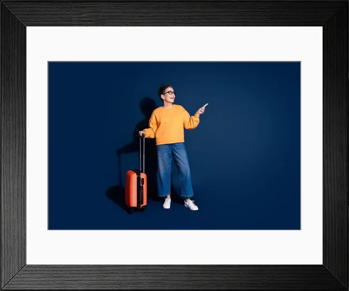 Framed Print : Full body photo of mature woman traveling suitcase point look empty space dressed stylish yellow clothes isolated Framed Print : Full body photo of mature woman traveling suitcase point look empty space dressed stylish yellow clothes isolated
