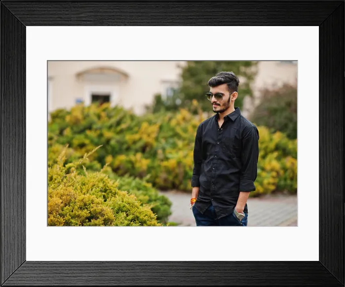 Framed Print : Indian stylish man at black shirt and sunglasses posed outdoor Framed Print : Indian stylish man at black shirt and sunglasses posed outdoor
