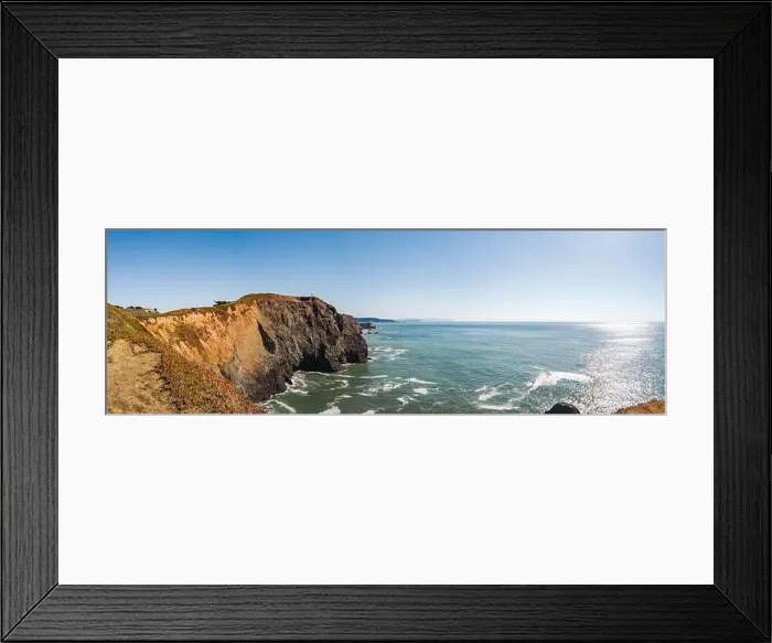 Framed Print : A tranquil beach scene featuring a collection of large rocks situated in the center of the frame Framed Print : A tranquil beach scene featuring a collection of large rocks situated in the center of the frame