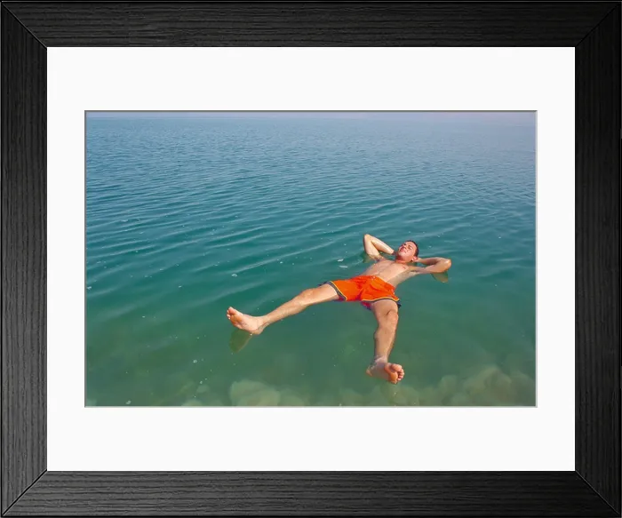 Framed Print : man floating at the dead sea Framed Print : man floating at the dead sea