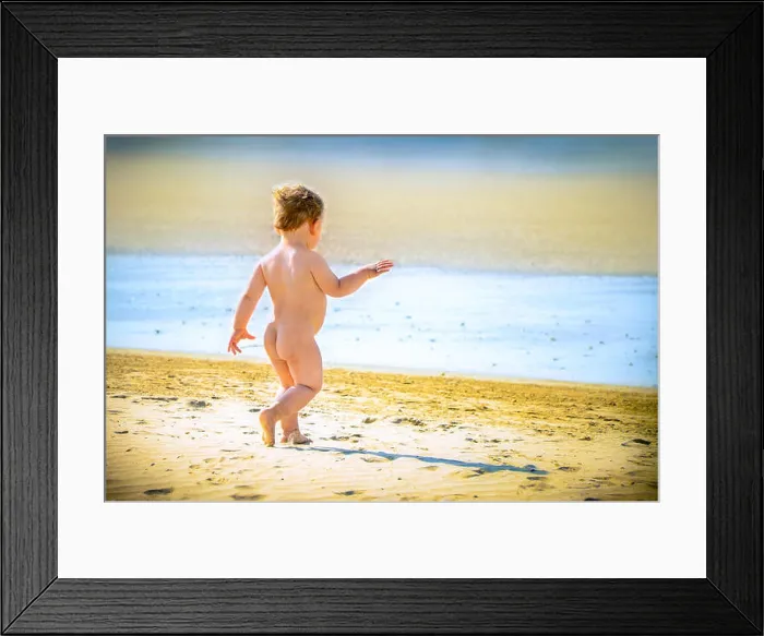 Framed Print : Little boy walks confidently free on the beach Framed Print : Little boy walks confidently free on the beach