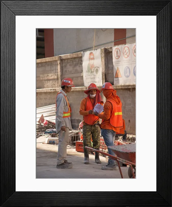 Framed Print : Construction workers wearing safety equipment at an outdoor meeting. Bangkok Thailand. Discussing their wages Framed Print : Construction workers wearing safety equipment at an outdoor meeting. Bangkok Thailand. Discussing their wages