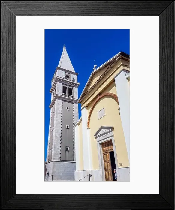 Framed Print : A view on a church and a bell tower from the bottom Framed Print : A view on a church and a bell tower from the bottom