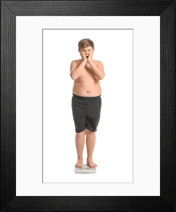 Framed Print : Overweight boy standing on scales against white background