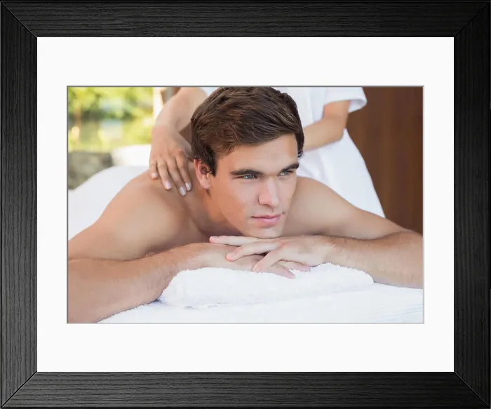 Framed Print : Man receiving shoulder massage at spa center