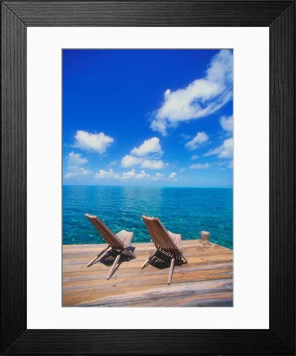 Framed Print : Wooden deck chairs looking out towards the horizon in the Caribbean Framed Print : Wooden deck chairs looking out towards the horizon in the Caribbean