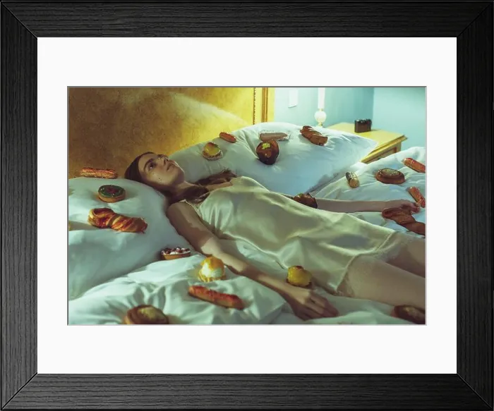 Framed Print : young woman in silk nightie lying on bed with many candies Framed Print : young woman in silk nightie lying on bed with many candies