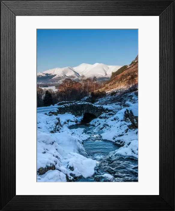 Framed Print : A snow covered winter scene at Ashness Bridge with Skiddaw mountain in the background Framed Print : A snow covered winter scene at Ashness Bridge with Skiddaw mountain in the background