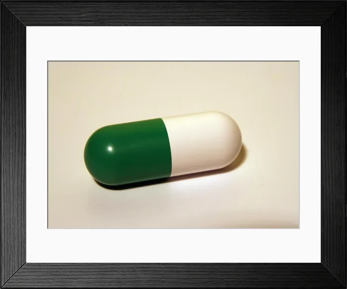 Framed Print : Green and white medical pill. Antibiotic capsule Framed Print : Green and white medical pill. Antibiotic capsule