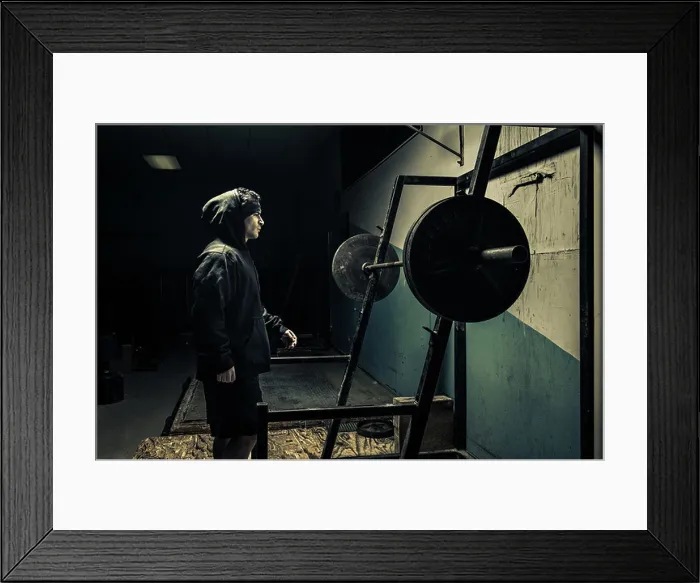 Framed Print : Weightlifter in dark gym Framed Print : Weightlifter in dark gym