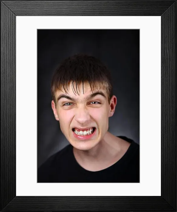 Framed Print : Portrait of Angry Young Man on the Black Background Framed Print : Portrait of Angry Young Man on the Black Background