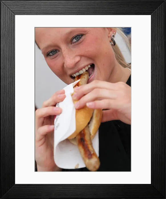 Framed Print : A woman eats bratwurst during the First Franconian Bratwurt summit meeting in Pegnitz Framed Print : A woman eats bratwurst during the First Franconian Bratwurt summit meeting in Pegnitz