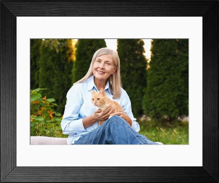 Framed Print : Senior woman with her cute cat in garden Framed Print : Senior woman with her cute cat in garden