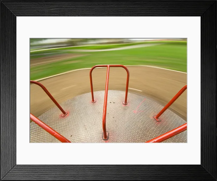 Framed Print : Children's Playground equipment - merry go round spinning very fast Framed Print : Children's Playground equipment - merry go round spinning very fast