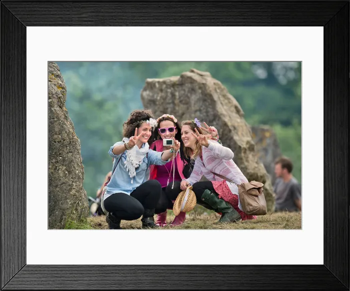 Framed Print : Glastonbury Festival 2013 UK A group of three girls record the moment at the stone circle Framed Print : Glastonbury Festival 2013 UK A group of three girls record the moment at the stone circle