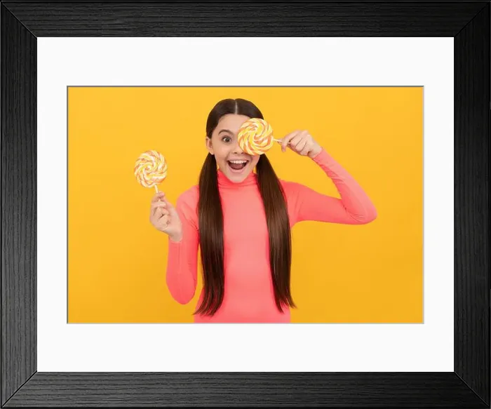 Framed Print : amazed teen girl with lollipop candy on stick on yellow background, sweet tooth Framed Print : amazed teen girl with lollipop candy on stick on yellow background, sweet tooth