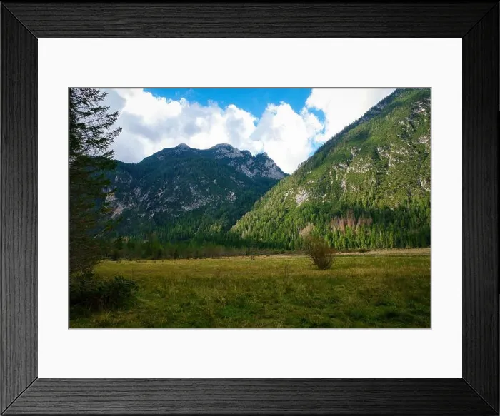 Framed Print : Majestic mountains rise high above lush green fields Framed Print : Majestic mountains rise high above lush green fields