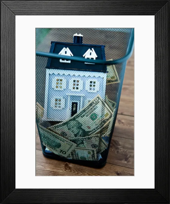 Framed Print : American dollar bills and model home in garbage can Framed Print : American dollar bills and model home in garbage can