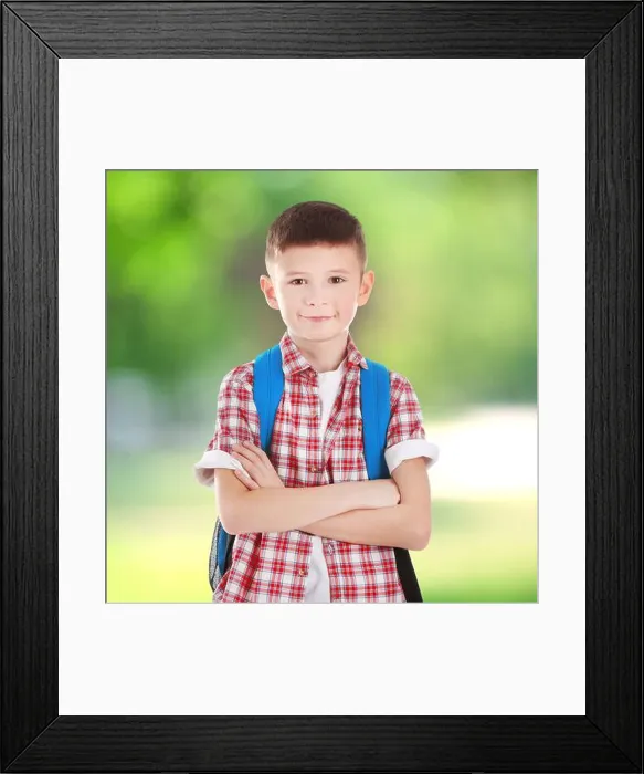 Framed Print : Cute boy with backpack on blurred green background. School concept Framed Print : Cute boy with backpack on blurred green background. School concept