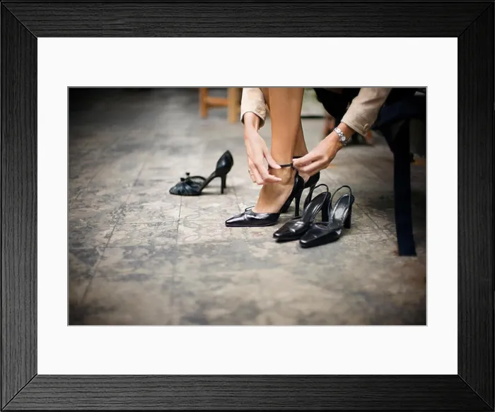 Framed Print : Cropped view of a woman trying on a new pair of sandals Framed Print : Cropped view of a woman trying on a new pair of sandals