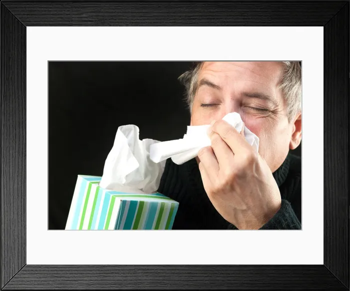 Framed Print : Close-up of a man blowing his nose while holding a tissue box Framed Print : Close-up of a man blowing his nose while holding a tissue box