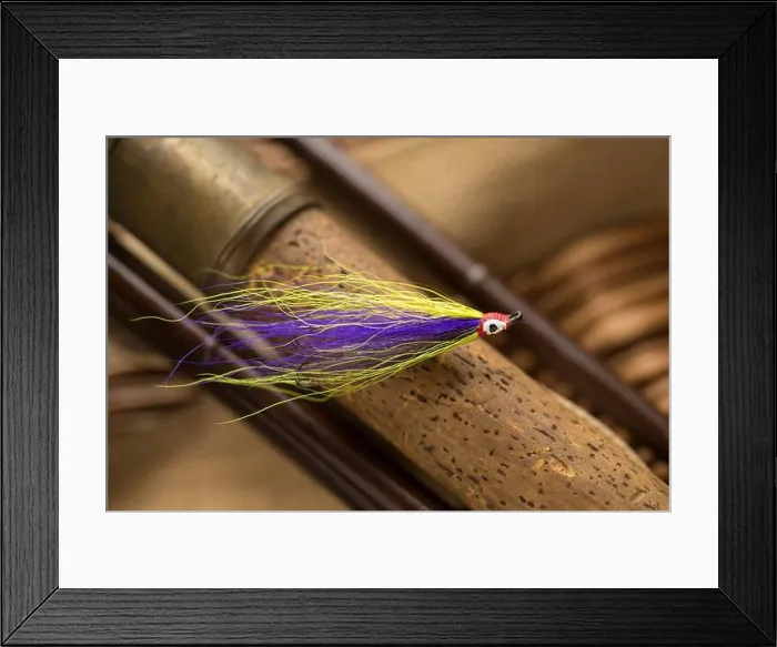 Framed Print : A single salmon fly that was probably homemade on the cork handle of an old wooden salmon fly fishing rod Framed Print : A single salmon fly that was probably homemade on the cork handle of an old wooden salmon fly fishing rod
