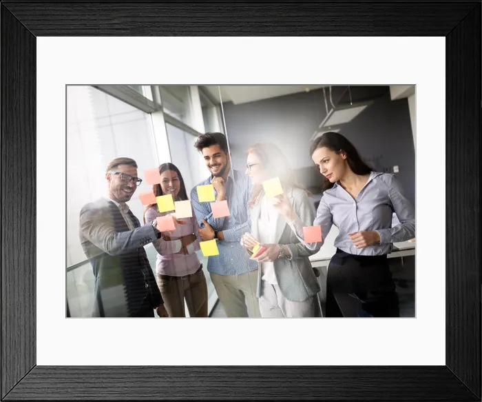 Framed Print : Business colleagues in conference meeting room during presentation