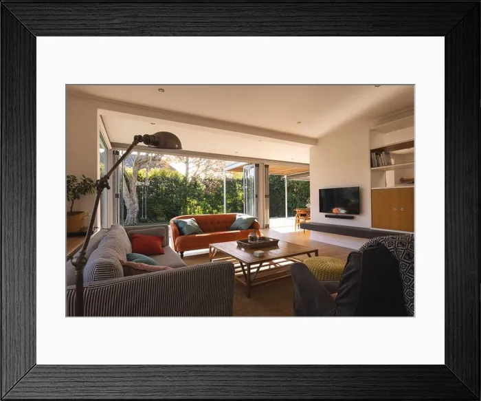 Framed Print : Interior of a living room with television, couch and armchair over big window and garden Framed Print : Interior of a living room with television, couch and armchair over big window and garden