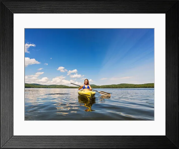 Framed Print : Young woman kayaking on lake Framed Print : Young woman kayaking on lake