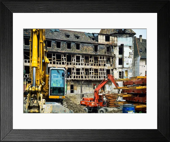 Framed Print : Yellow and red diggers on ancient half-timbered house renovation site, Strasbourg, Alsace, France