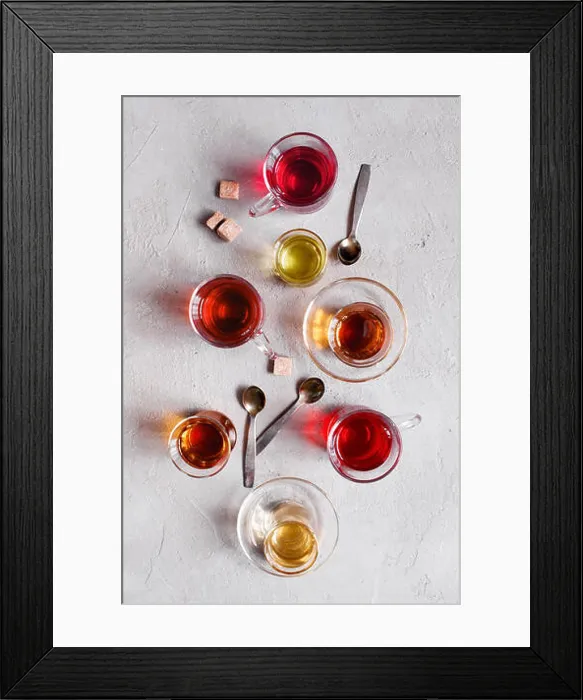 Framed Print : Glass cups with various types of tea on the textured grey table, top view