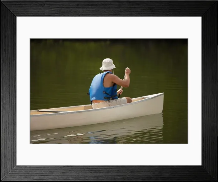 Framed Print : Side profile of a person boating in a river Framed Print : Side profile of a person boating in a river