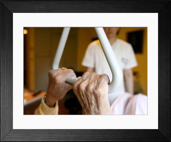 Framed Print : A resident of a senior citizen centre holds on to a handle in Hamburg Framed Print : A resident of a senior citizen centre holds on to a handle in Hamburg