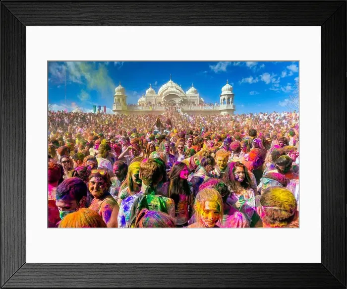 Framed Print : Thousands of people throw colored powder into the air during the Holi Festival of Colors at the Sri Sri Radha Krishna Framed Print : Thousands of people throw colored powder into the air during the Holi Festival of Colors at the Sri Sri Radha Krishna