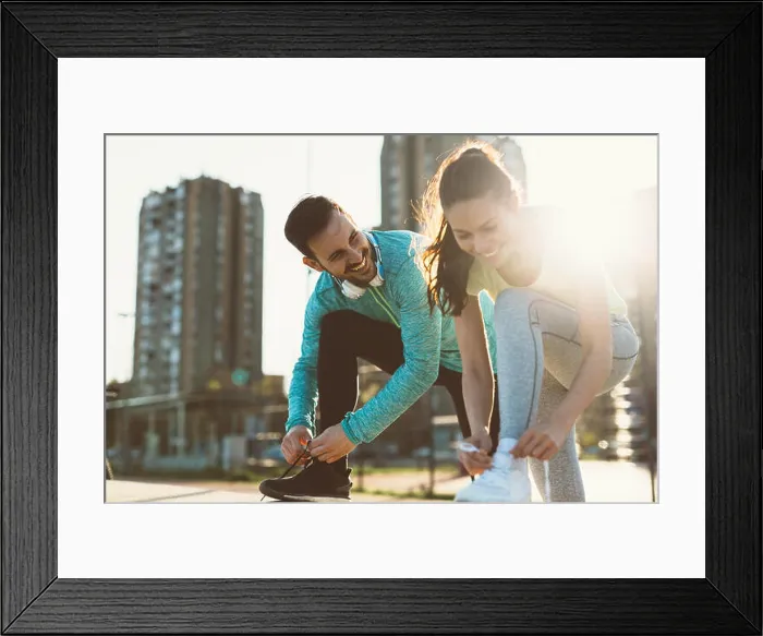 Framed Print : Runners tying running shoes and getting ready to run Framed Print : Runners tying running shoes and getting ready to run