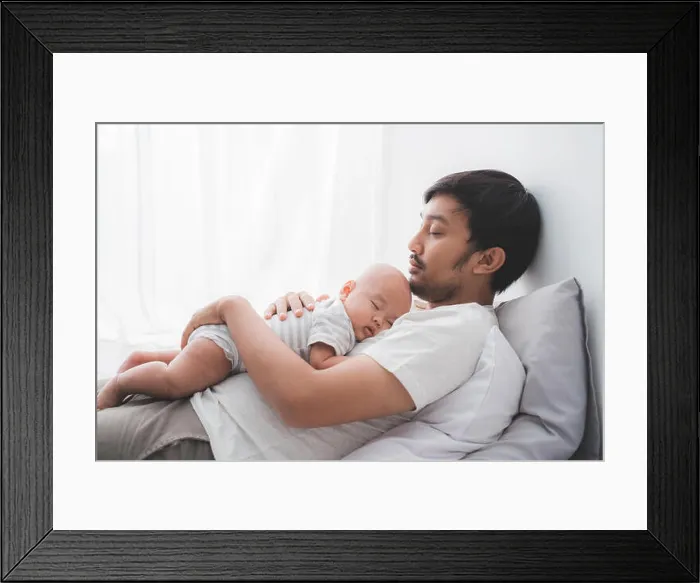 Framed Print : dad with his infant boy sleeping on his chest Framed Print : dad with his infant boy sleeping on his chest