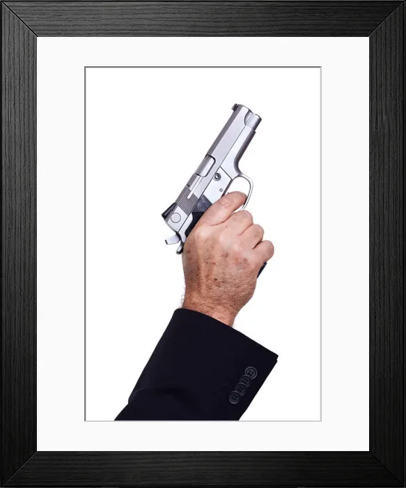 Framed Print : The hand mature adult man wearing suit holding 9mm gun his right hand aiming it diagonallyupwards Framed Print : The hand mature adult man wearing suit holding 9mm gun his right hand aiming it diagonallyupwards