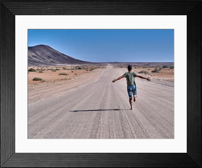 Framed Print : Man running freely on an endless road, rear view, Damaraland, Namibia Framed Print : Man running freely on an endless road, rear view, Damaraland, Namibia