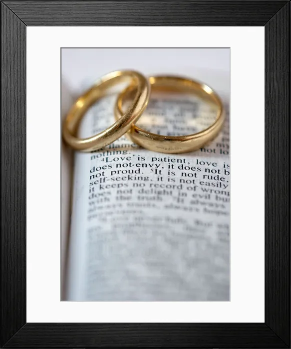 Framed Print : Two gold wedding rings lie on an open Bible. The verses are from 1 Corinthians 13 Framed Print : Two gold wedding rings lie on an open Bible. The verses are from 1 Corinthians 13