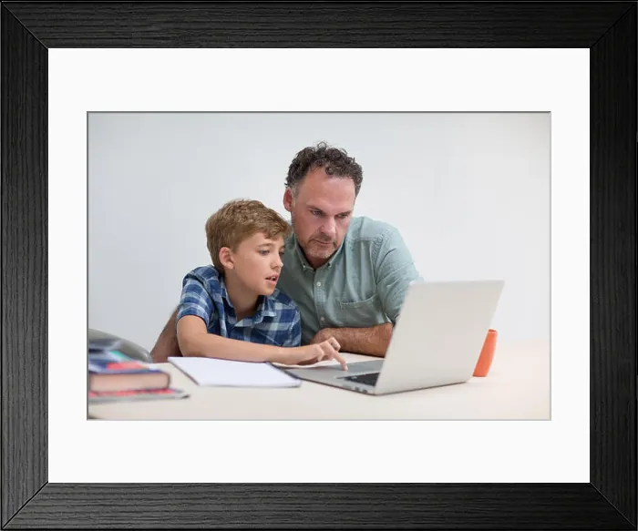 Framed Print : Father helping son with homework Framed Print : Father helping son with homework
